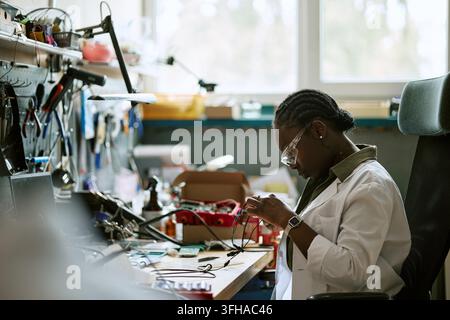 Black Woman Engineer Testing Electronic Components in Lab Stock Photo