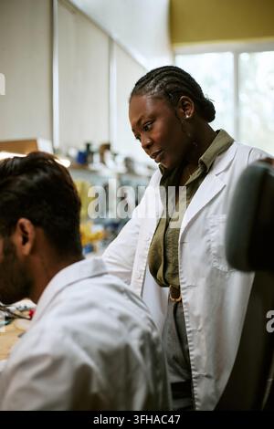 Black Woman Scientist Working with Colleague in Modern Laboratory Stock Photo