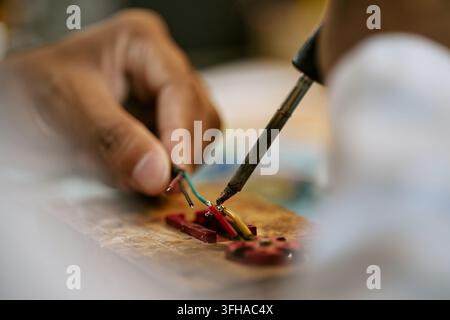 Hands of Man Soldering Electric Wires for Hardware Repair Stock Photo