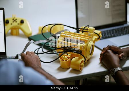 Black Engineers Developing Underwater Robotic Prototype with Laptop Stock Photo