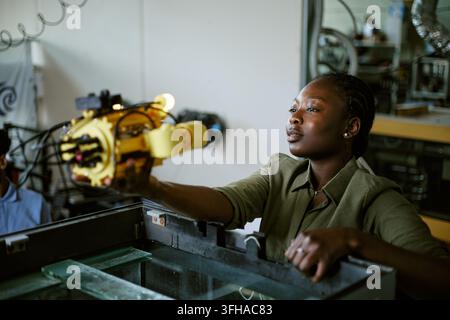 Black Woman Engineer Testing Underwater Robotics Prototype in Lab Stock Photo