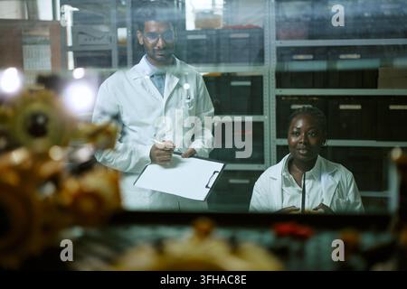 Portrait of Multiethnic Engineers Working in Robotics Lab Stock Photo
