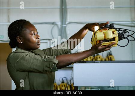 Black Woman Testing Underwater Robotic Drone in Laboratory Stock Photo