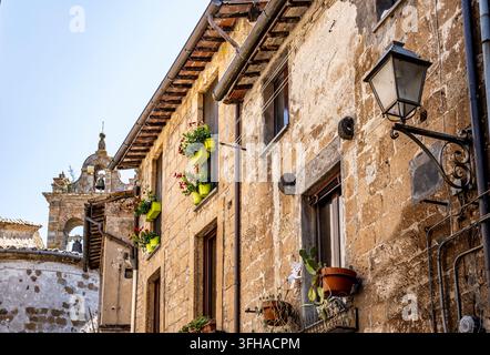 Picturesque view of historic Orvieto with traditional windows, flower pots and medieval buildings, Orvieto, Umbria, Italy Stock Photo