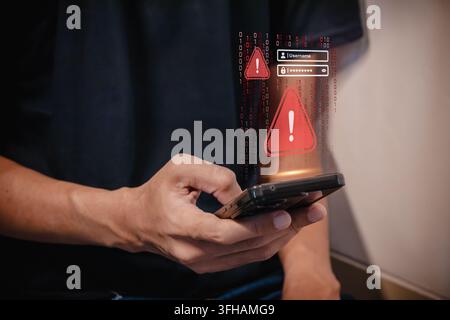 A digital waning alert and login field on a smartphone screen, representing a cyber threat, data breach, or phishing attempt Stock Photo