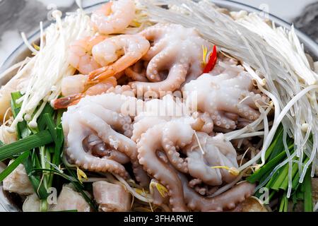 Korean seafood hot pot with fresh octopus, shrimp and vegetables served at a restaurant. Stock Photo
