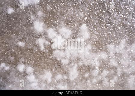 white sea salt crystals forming in evaporation pan at traditional salt marsh Stock Photo