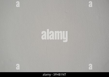 Full frame minimal background texture of a smooth painted light grey plaster wall surface. Stock Photo