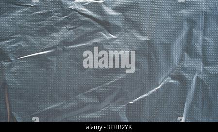 Black plastic bag texture background crumpled polyethylene sheet abstract surface copy space Stock Photo