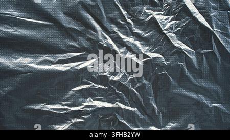 Dark gray crumpled plastic bag texture background abstract wrinkled surface macro detail Stock Photo