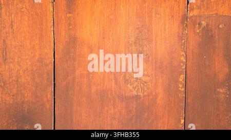 Smooth vintage brown wood plank texture surface with vertical seams natural subtle grain and warm lighting for design backdrops Stock Photo