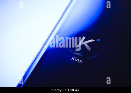 Paris, France - September 16, 2026: Kimi AI assistant application logo displayed on a smartphone screen with blue light. Stock Photo