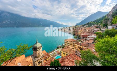 Panoramic view over Limone sul Garda village with San Rocco church bell tower and turquoise waters of Lake Garda. Brescia province, Lombardy, Italy Stock Photo