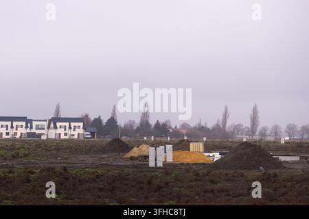 Large piles of excavated soil at a construction site with rough dirt ...