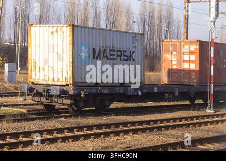 Leszno, Poland - December 15, 2025: Maersk storage container resting on a railway flatcar at a terminal, representing logistics efficiency, freight mo Stock Photo