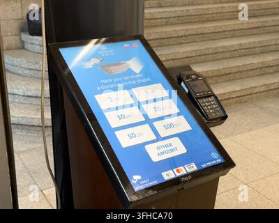 Wroclaw, Poland - December 15, 2025: Electronic touch screen terminal for chapel financial support, featuring card payment options to facilitate conve Stock Photo