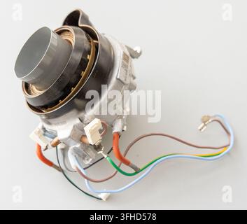 An electronic appliance component with colorful wires is displayed on white Stock Photo
