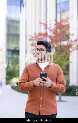 Young man using smartphone for digital communication and mobile technology. Stock Photo