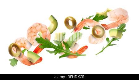 Shrimps, avocado pieces, arugula leaves and sliced olives flying in air against white background Stock Photo