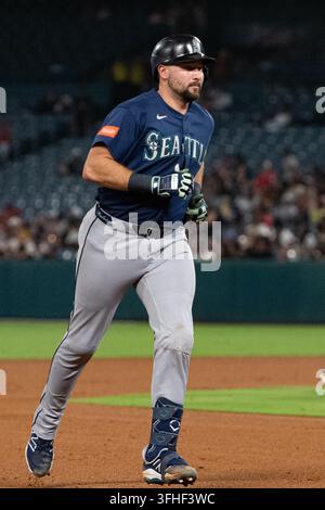 Seattle Mariners catcher Cal Raleigh smiles while celebrating a win ...