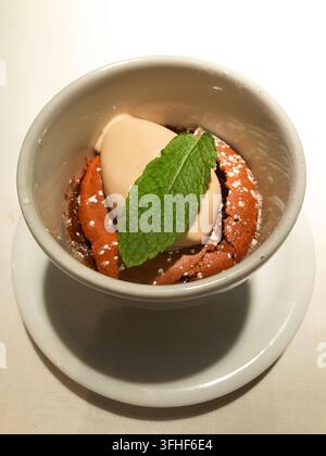 Chocolate mousse with coffee ice cream and mint leaf. Stock Photo