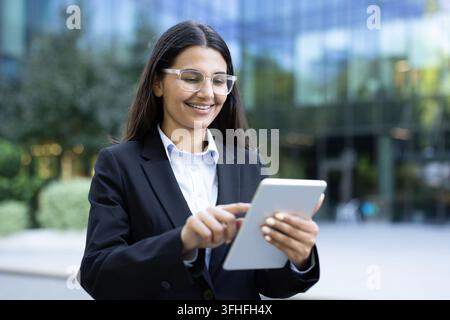 Business woman using digital tablet for remote work and corporate communication. Stock Photo