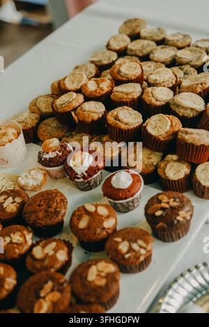 Close-up of various freshly baked muffins and cupcakes with toppings Stock Photo