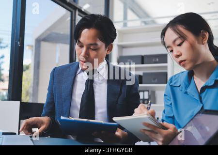 Business professional analyzing financial data on digital tablet dashboard with calculator and laptop, representing accounting software, ERP system in Stock Photo