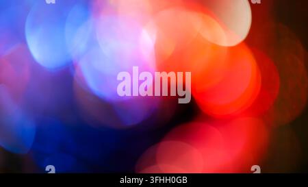 Abstract blurred bokeh background with soft red and blue circles and white highlights Stock Photo