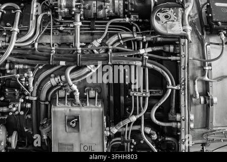 Detailed monochrome abstract view of complex piping, fuel lines, and machinery on an aero jet engine at the Jet Age Museum in Gloucester, UK Stock Photo