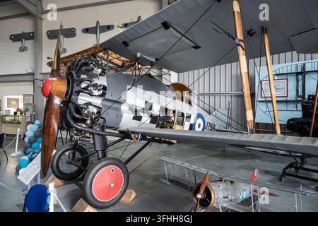 A preserved historic Gloster Gamecock Mk I biplane fighter, serial J7904, on indoor display inside the hangar at the Jet Age Museum in Gloucester, UK Stock Photo