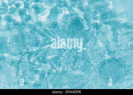 Blue Swimming Pool Water with Sunlight Ripples Background Stock Photo