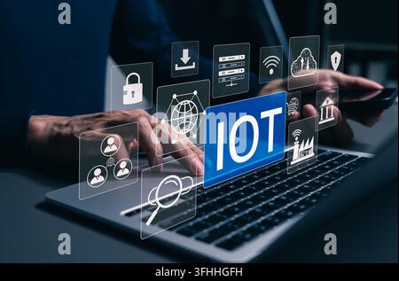 IoT Internet of Things technology concept. User typing on laptop and IoT interface, connected devices, smart networks, cloud computing, cybersecurity, Stock Photo