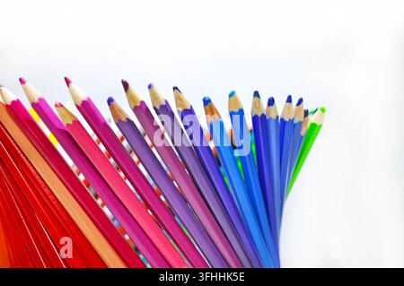 Colorful sharpened pencils arranged in a fan on a white background with ample copy space, representing creativity, drawing, education and art. Stock Photo