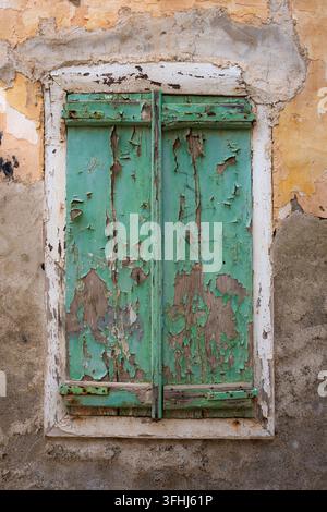 Weathered Green Wooden Shutters with Peeling Paint Stock Photo