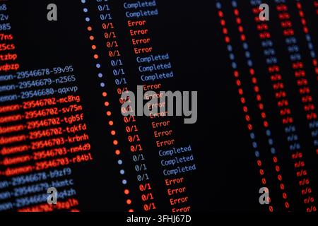 Digital interface displaying a list of software operations with multiple error notifications and completed status indicators on a black monitor for te Stock Photo