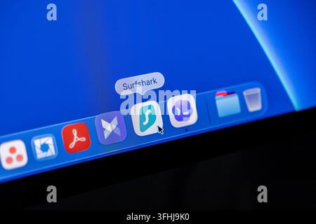 Poznan, Poland - February 23, 2026: Surfshark app icon sitting on a macOS dock interface being selected with a cursor to launch a virtual private netw Stock Photo