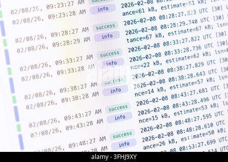 Rows of system log activity appear on a monitor, featuring status indicators for monitoring backend tasks, IT infrastructure maintenance, and complex Stock Photo
