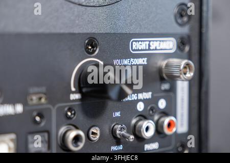 The rear interface of a powered loudspeaker shows a rotary knob alongside input jacks and switches, capturing the technical details essential for home Stock Photo