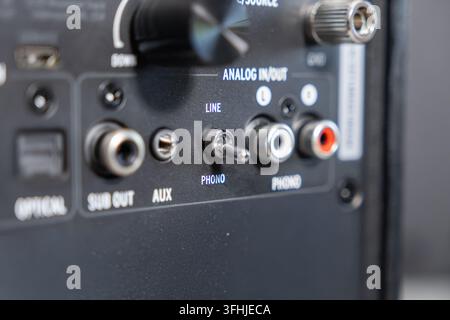 An audio amplifier rear panel showing essential analog connections, including a toggle switch for phono input, illustrating technical setup for high f Stock Photo