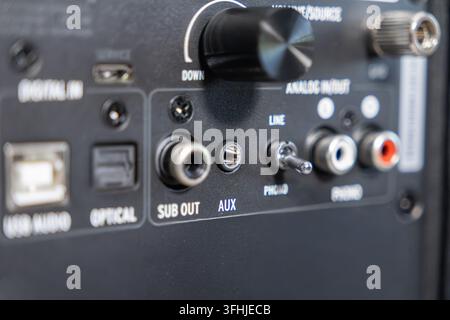 The rear connection panel of a modern amplifier features various ports for integrated stereo systems where cables enable connectivity for professional Stock Photo