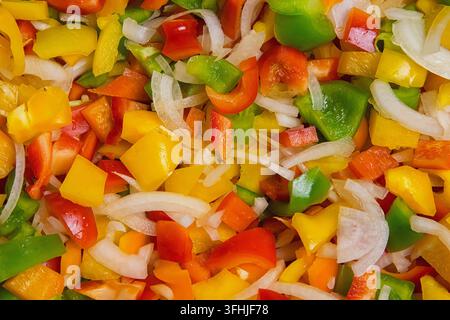 Colored pepper and onion are sliced in a bowl. salad for the winter. conservation Stock Photo