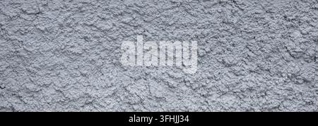 Grey rough stucco wall showing detailed plaster texture and weathered cement surface Stock Photo