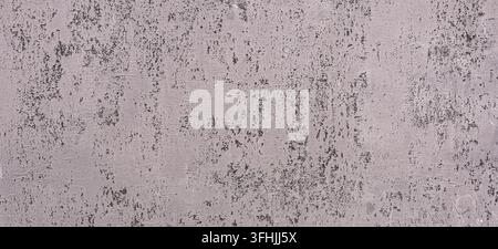 Grunge concrete wall featuring rough texture and peeling gray paint creating an abstract background Stock Photo
