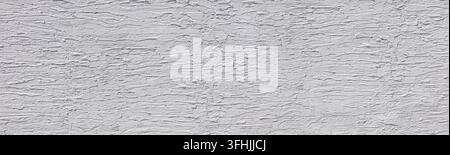 Rough white stucco wall texture creating an abstract textured background Stock Photo