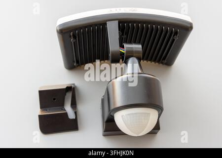 Black and white security light components are shown on a clean white background Stock Photo