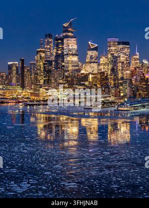 Aerial view of a frozen river with ice floes and snow-covered banks in ...