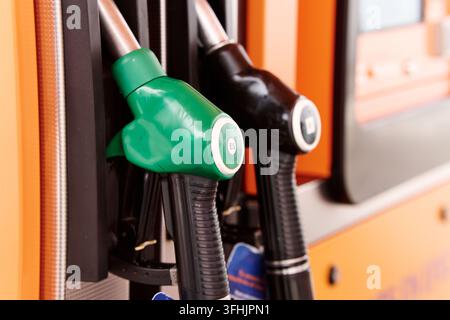 Gas pump nozzles showing high fuel prices at a station. Illustrating energy crisis, inflation, and economic challenges Stock Photo