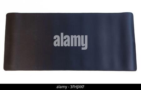 A large plain black mouse pad rests on a white background Stock Photo