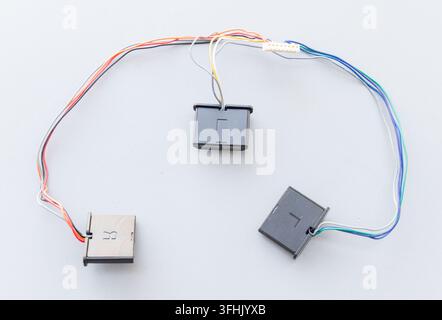 Electronic wires, modules, and a connector are arranged on a plain surface Stock Photo